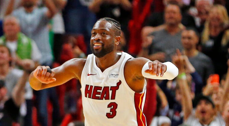 Miami Heat guard Dwyane Wade (3) runs up the court to celebrate the win against the Dallas Mavericks at an NBA basketball game, Thursday, March 28, 2019, in Miami. A P DO NOT U S E
