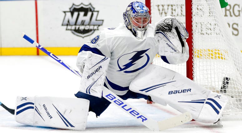 This March 23, 2019, file photo shows Tampa Bay Lightning goaltender Andrei Vasilevskiy (88) deflecting a shot with his glove in the second period of an NHL hockey game against the St. Louis Blues, in St. Louis. AP DO NOT USE
