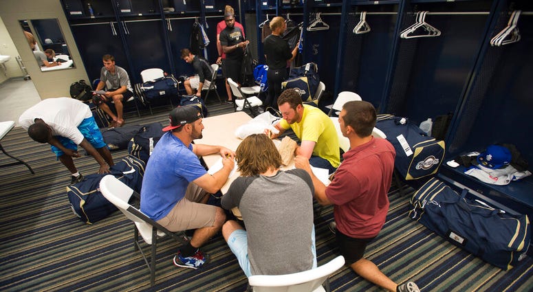 FILE - In this April 8, 2015, file photo, members of the Biloxi Shuckers minor league baseball team eat lunch before practice at the Pensacola Blue Wahoos' stadium in Pensacola, Fla AP DO NOT USE