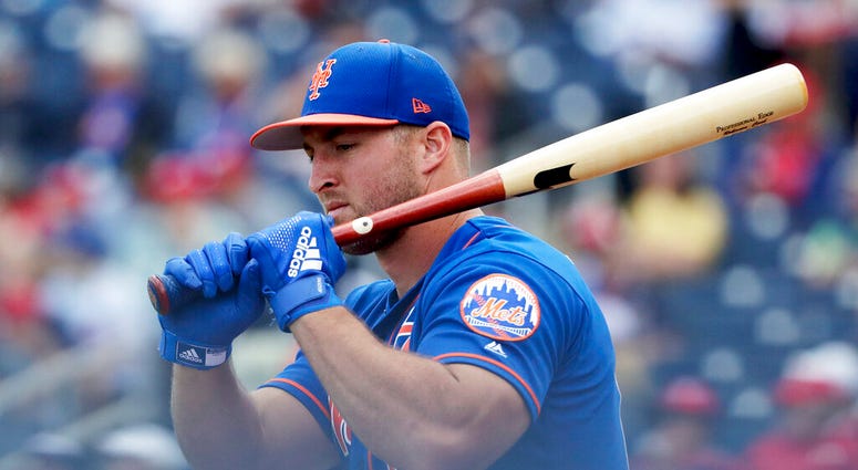 In this March 7, 2019, file photo, New York Mets' Tim Tebow loosens up before batting in an exhibition spring training baseball game against the Washington Nationals in West Palm Beach, Fla. AP DO NOT USE