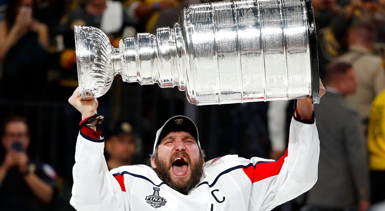 In this June 7, 2018, file photo, Washington Capitals left wing Alex Ovechkin, of Russia, hoists the Stanley Cup AP DO NOT USE