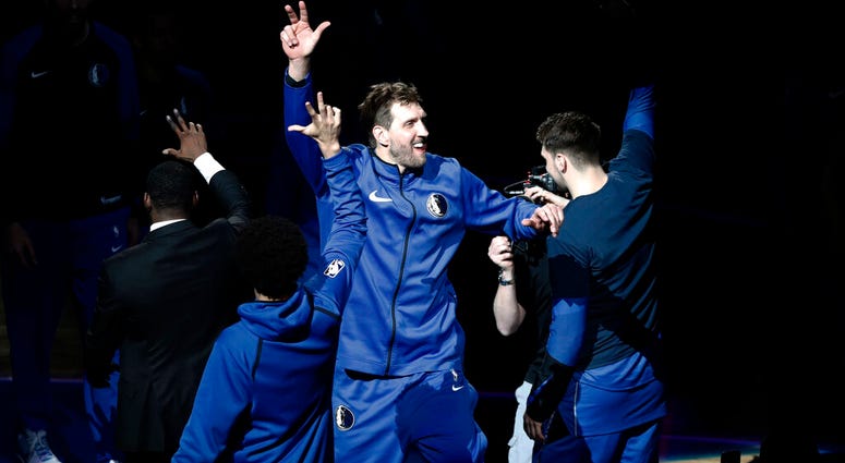 Dallas Mavericks' Dirk Nowitzki (41) is introduced for the team's NBA basketball game against the Phoenix Suns in Dallas, Tuesday, April 9, 2019. AP DO NOT USE