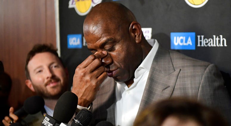 Magic Johnson wipes his eyes as he speaks to reporters prior to an NBA basketball game between the Los Angeles Lakers and the Portland Trail Blazers on Tuesday, April 9, 2019, in Los Angeles. AP DO NOT USE