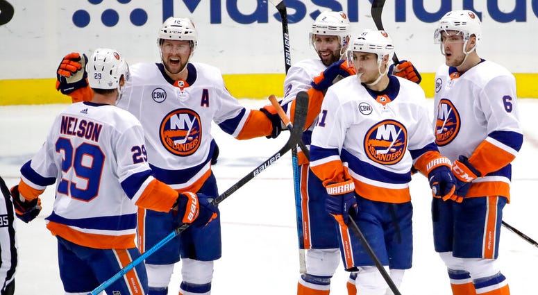 New York Islanders' Josh Bailey (12) celebrates his empty-net goal against the Pittsburgh Penguins during the third period in Game 4 of an NHL hockey first-round playoff series in Pittsburgh, Tuesday, April 16, 2019. AP DO NOT USE