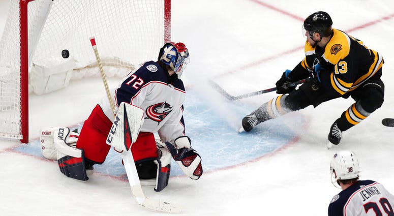 Boston Bruins center Charlie Coyle (13) beats Columbus Blue Jackets goaltender Sergei Bobrovsky (72) for the game-winning goal during overtime of Game 1 of an NHL hockey second-round playoff series, Thursday, April 25, 2019, in Boston AP DO NOT USE