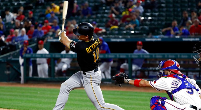 Pittsburgh Pirates' Bryan Reynolds follows through on a solo home run in front of Texas Rangers catcher Isiah Kiner-Falefa during the 11th inning of a baseball game in Arlington, Texas, Tuesday, April 30, 2019. AP DO NOT USE