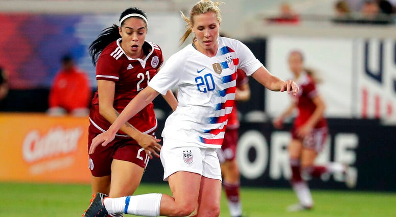 In this April 5, 2018, file photo, United States' Allie Long (20) blocks Mexico's Renae Cuellar (21) path to the goal during the second half of an international friendly soccer match, in Jacksonville, Fla. AP DO NOT USE