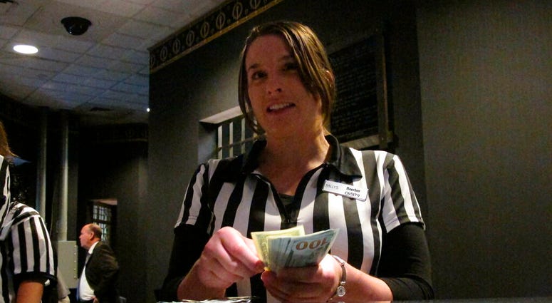 In this July 30, 2018 photo, Heather Warker, an employee of the sports betting lounge at Bally's casino in Atlantic City N.J. AP DO NOT USE