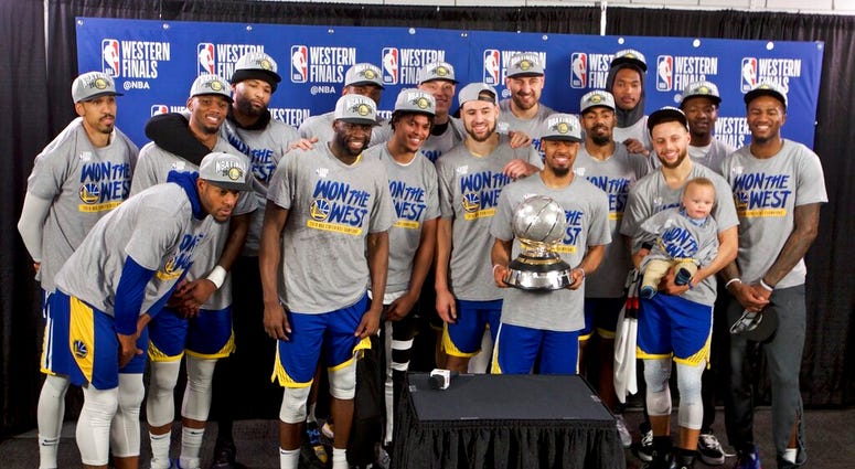 The Golden State Warriors players pose with the Western Conference Championship trophy The Golden State Warriors players pose with the Western Conference Championship trophy