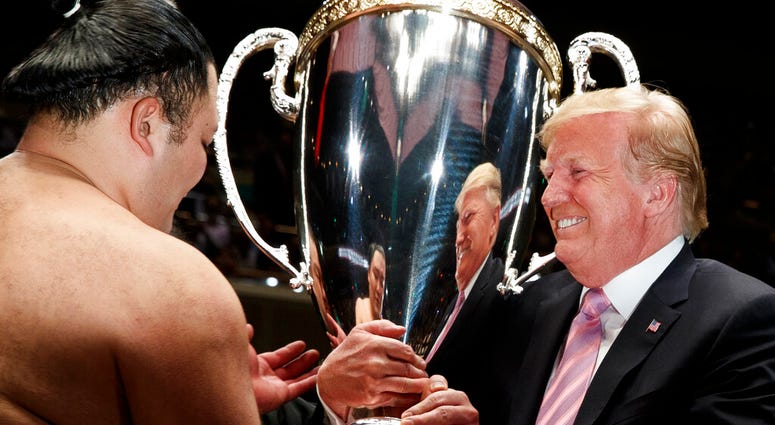 President Donald Trump presents the "President's Cup" to Tokyo Grand Sumo Tournament winner Asanoyama, at Ryogoku Kokugikan Stadium, Sunday, May 26, 2019, in Tokyo. President Donald Trump presents the "President's Cup" to Tokyo Grand Sumo Tournament winner Asanoyama, at Ryogoku Kokugikan Stadium, Sunday, May 26, 2019, in Tokyo.