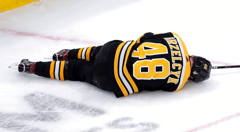 Boston Bruins' Matt Grzelcyk lies injured on the ice during the first period in Game 2 of the NHL hockey Stanley Cup Final against the St. Louis Blues, Wednesday, May 29, 2019, in Boston. Boston Bruins' Matt Grzelcyk lies injured on the ice during the first period in Game 2 of the NHL hockey Stanley Cup Final against the St. Louis Blues, Wednesday, May 29, 2019, in Boston.