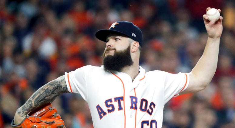 file photo, Houston Astros starting pitcher Dallas Keuchel throws against the Boston Red Sox