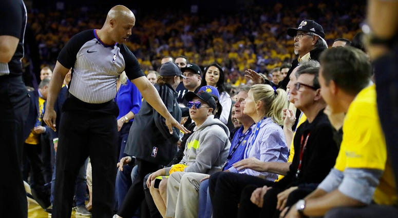 referee Marc Davis, left, gestures toward Golden State Warriors investor Mark Stevens referee Marc Davis, left, gestures toward Golden State Warriors investor Mark Stevens