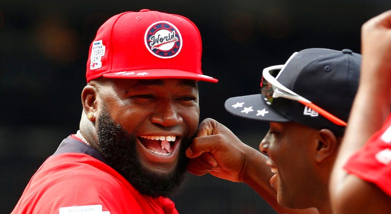 In this July 15, 2018, file photo, World Team Manager David Ortiz (34) speaks with U.S. Team Manager Torrii Hunter, before the All-Star Futures baseball game at Nationals Park, in Washington. AP DO NOT USE