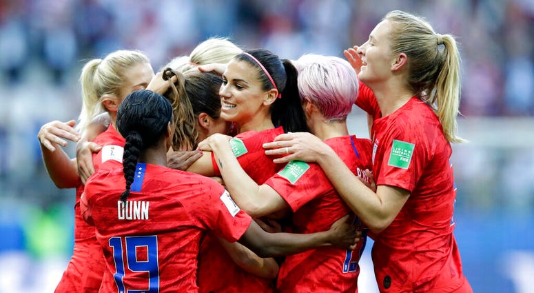 United States' Alex Morgan, center, celebrates after scoring the opening goal during the Women's World Cup Group F soccer match between United States and Thailand at the Stade Auguste-Delaune in Reims, France, Tuesday, June 11, 2019. AP DO NOT USE