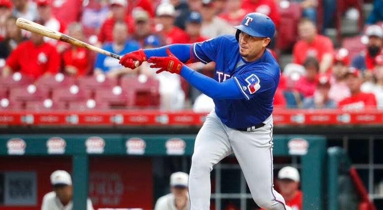 Texas Rangers' Asdrubal Cabrera hits an RBI single off Cincinnati Reds starting pitcher Tanner Roark during the first inning of a baseball game Saturday, June 15, 2019, in Cincinnati. Texas Rangers' Asdrubal Cabrera hits an RBI single off Cincinnati Reds starting pitcher Tanner Roark during the first inning of a baseball game Saturday, June 15, 2019, in Cincinnati.