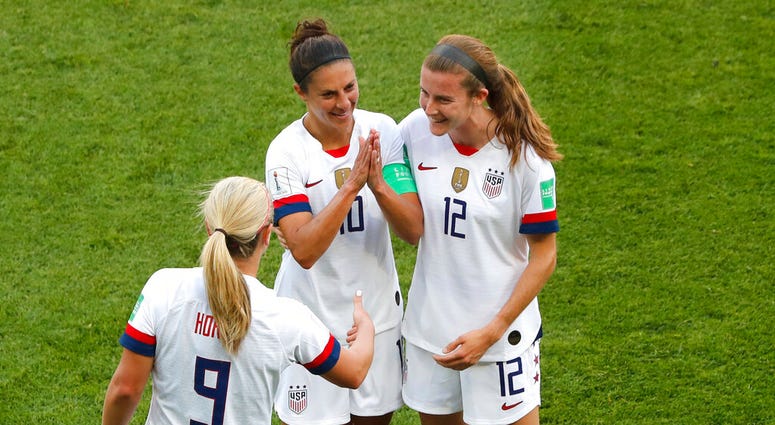 United States' Carli Lloyd , center, celebrates with Lindsey Horan and Tierna Davidson, right, after scoring the opening goal during the Women's World Cup Group F soccer match between the United States and Chile at the Parc des Princes in Paris, Sunday, J United States' Carli Lloyd , center, celebrates with Lindsey Horan and Tierna Davidson, right, after scoring the opening goal during the Women's World Cup Group F soccer match between the United States and Chile at the Parc des Princes in Paris, Sunday, J