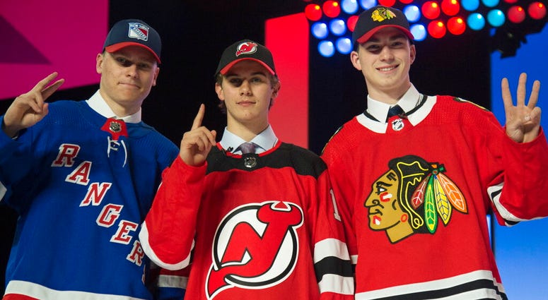 New York Rangers draft pick Kaapo Kakko, left; New Jersey Devils pick Jack Hughes, center; and Chicago Blackhawks pick Kirby Dach pose for photos during the first round of the NHL hockey draft New York Rangers draft pick Kaapo Kakko, left; New Jersey Devils pick Jack Hughes, center; and Chicago Blackhawks pick Kirby Dach pose for photos during the first round of the NHL hockey draft
