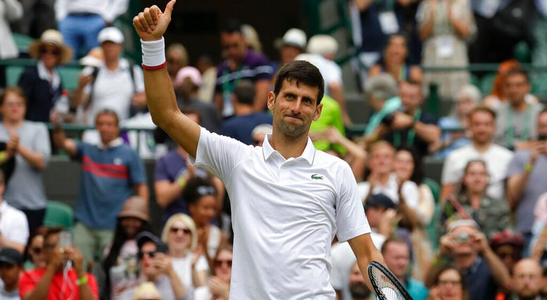 Serbia's Novak Djokovic celebrates defeating Ugo Humbert of France in a men's singles match during day seven of the Wimbledon Tennis Championships in London, Monday, July 8, 2019. AP DO NOT USE