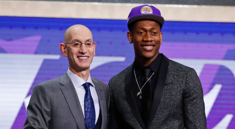 In this Thursday, June 20, 2019, file photo, Virginia's De'Andre Hunter, right, is greeted by NBA Commissioner Adam Silver after being selected with the fourth pick overall by the Los Angeles Lakers during the NBA basketball draft in New York. ap do not use