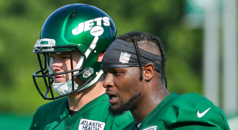 New York Jets' Le'Veon Bell, right, talks with quarterback Sam Darnold during practice at the NFL football team's training camp in Florham Park, N.J., Thursday, July 25, 2019. New York Jets' Le'Veon Bell, right, talks with quarterback Sam Darnold during practice at the NFL football team's training camp in Florham Park, N.J., Thursday, July 25, 2019.