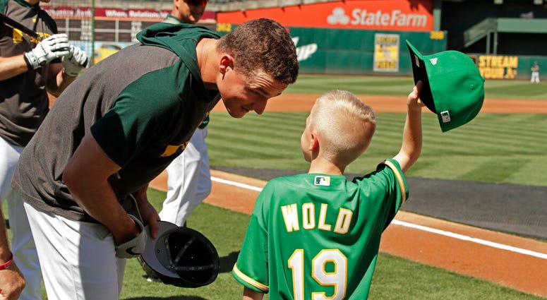 Eight-year-old August Wold (19) compares his haircut to Oakland Athletics' Matt Chapman's Eight-year-old August Wold (19) compares his haircut to Oakland Athletics' Matt Chapman's