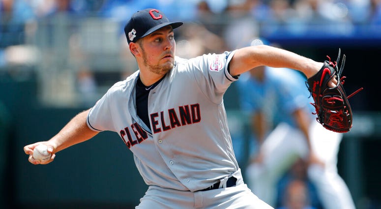 Cleveland Indians pitcher Trevor Bauer throws against the Kansas City Royals in the first inning of a baseball game at Kauffman Stadium in Kansas City, Mo., Sunday, July 28, 2019. AP DO NOT USE