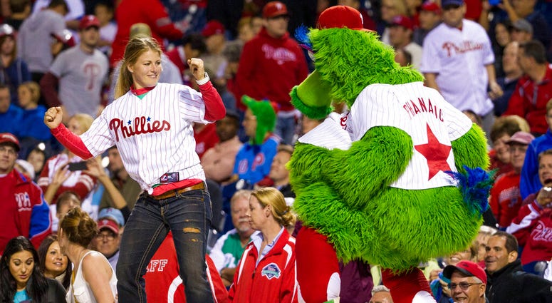 the Phillies Phanatic dancing with a fan the Phillies Phanatic dancing with a fan