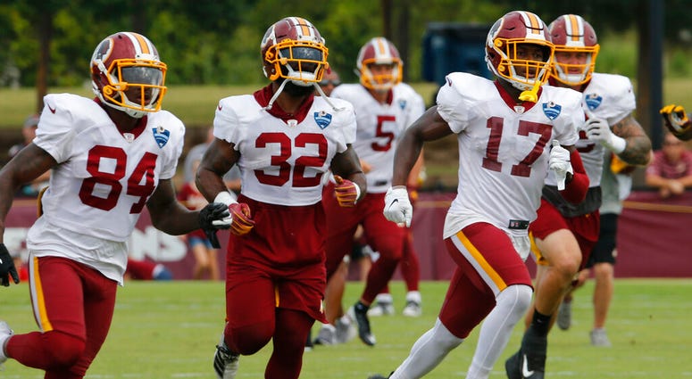 In this Aug. 5, 2019, file photo, Washington Redskins wide receiver Terry McLaurin (17) runs drills with teammates Samaje Perine (32) and Darlin Kidsy Jr., (84) during the Washington Redskins NFL football training camp in Richmond, Va. AP DO NOT USE
