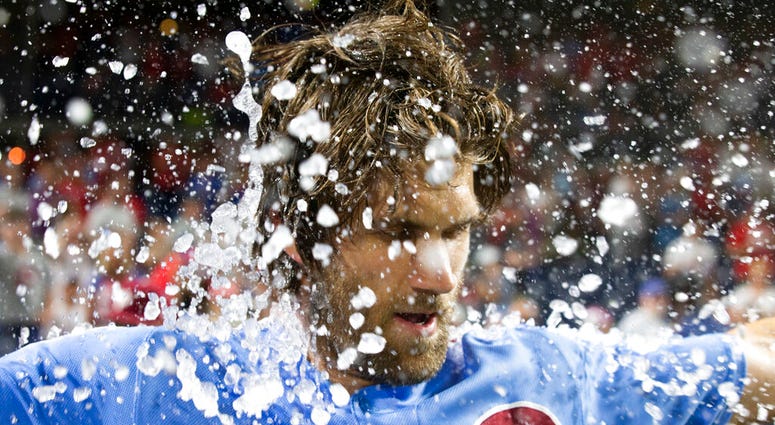 Philadelphia Phillies' Bryce Harper is doused following his grand slam ended the team's baseball game against the Chicago Cubs, Thursday, Aug. 15, 2019, in Philadelphia. AP DO NOT USE