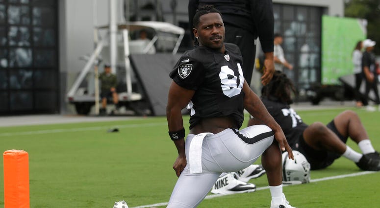 Oakland Raiders' Antonio Brown stretches during NFL football practice in Alameda, Calif., Tuesday, Aug. 20, 2019. Oakland Raiders' Antonio Brown stretches during NFL football practice in Alameda, Calif., Tuesday, Aug. 20, 2019.
