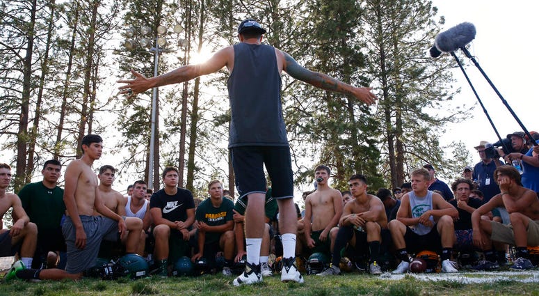 former Paradise High School football player Jeff Maehl, who played in the NFL, talks to the team after practice in Paradise, Calif. former Paradise High School football player Jeff Maehl, who played in the NFL, talks to the team after practice in Paradise, Calif.