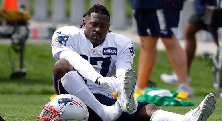 New England Patriots wide receiver Antonio Brown puts on his shoe during an NFL football practice, Wednesday, Sept. 18, 2019, in Foxborough, Mass. New England Patriots wide receiver Antonio Brown puts on his shoe during an NFL football practice, Wednesday, Sept. 18, 2019, in Foxborough, Mass.