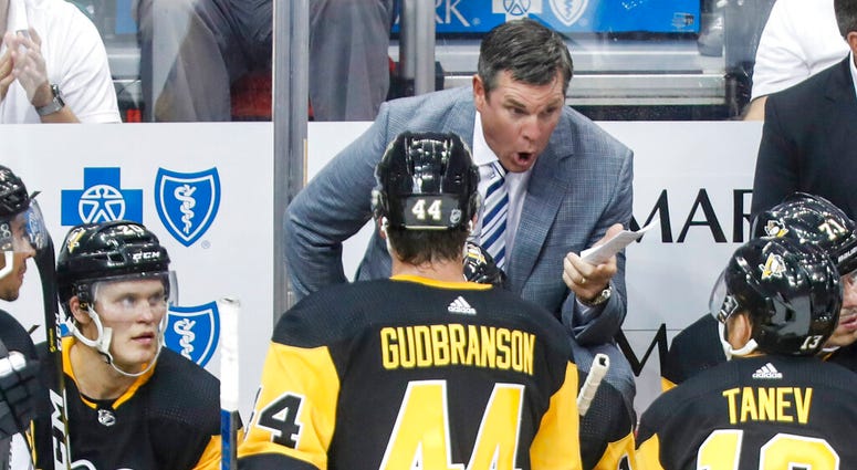 Pittsburgh Penguins head coach Mike Sullivan, center top, talks to his team in the third period of a preseason NHL hockey game against the Columbus Blue Jackets, Thursday, Sept. 19, 2019, in Pittsburgh.