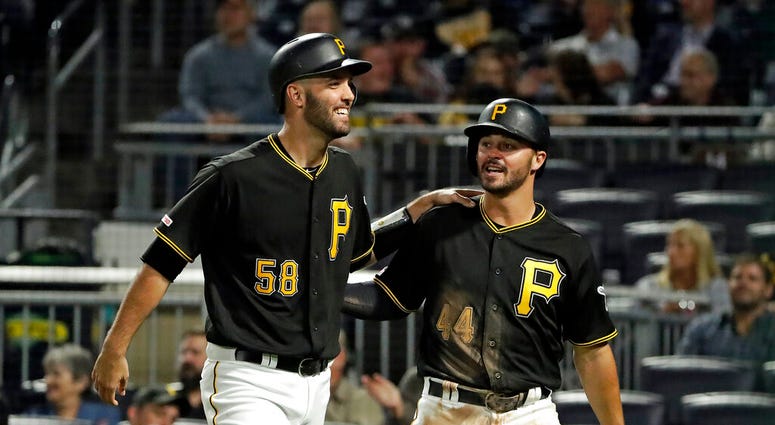 Pittsburgh Pirates' Kevin Kramer (44) and Jacob Stallings return to the dugout after scoring on a single by Erik Gonzalez off Chicago Cubs starting pitcher Kyle Hendricks during the seventh inning of a baseball game in Pittsburgh, Tuesday, Sept. 24, 2019. Pittsburgh Pirates' Kevin Kramer (44) and Jacob Stallings return to the dugout after scoring on a single by Erik Gonzalez off Chicago Cubs starting pitcher Kyle Hendricks during the seventh inning of a baseball game in Pittsburgh, Tuesday, Sept. 24, 2019.