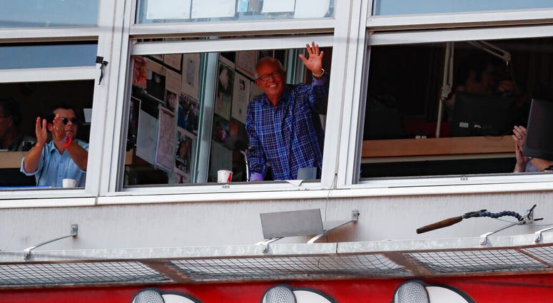 Cincinnati Reds announcer Marty Brennaman, center, waves to the crowd after the close of the fourth inning of a baseball game against the Milwaukee Brewers, Thursday, Sept. 26, 2019, in Cincinnati. ( Cincinnati Reds announcer Marty Brennaman, center, waves to the crowd after the close of the fourth inning of a baseball game against the Milwaukee Brewers, Thursday, Sept. 26, 2019, in Cincinnati. (