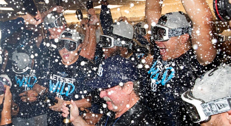 Tampa Bay Rays players celebrate in the clubhouse after they defeated the Toronto Blue Jays and clinched an MLB American League wild-card berth in Toronto, Friday, Sept. 27, 2019. Tampa Bay Rays players celebrate in the clubhouse after they defeated the Toronto Blue Jays and clinched an MLB American League wild-card berth in Toronto, Friday, Sept. 27, 2019.