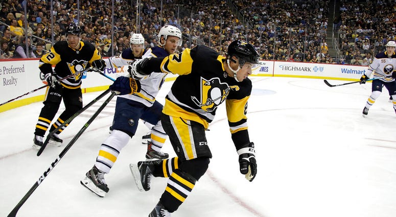Pittsburgh Penguins' Sidney Crosby (87) can't get his stick untangled from Buffalo Sabres' Vladimir Sobotka during the period of an NHL hockey game in Pittsburgh, Thursday, Oct. 3, 2019. Pittsburgh Penguins' Sidney Crosby (87) can't get his stick untangled from Buffalo Sabres' Vladimir Sobotka during the period of an NHL hockey game in Pittsburgh, Thursday, Oct. 3, 2019.