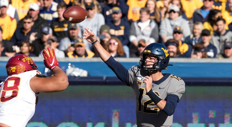 West Virginia quarterback Austin Kendall (12) attempts a pass during the first half of an NCAA college football game against Iowa State Saturday, Oct. 12, 2019, in Morgantown, W.Va. West Virginia quarterback Austin Kendall (12) attempts a pass during the first half of an NCAA college football game against Iowa State Saturday, Oct. 12, 2019, in Morgantown, W.Va.