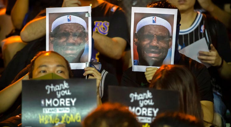 Demonstrators hold up photos of LeBron James grimacing during a rally at the Southorn Playground in Hong Kong, Tuesday, Oct. 15, 2019. AP DO NOT USE