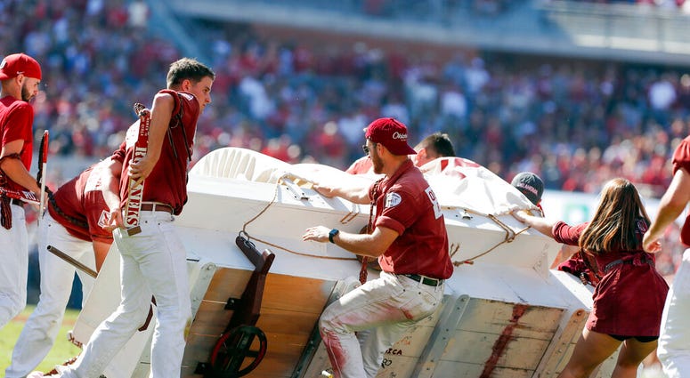 The Oklahoma Sooner Schooner flipped over during a touchdown celebration on the field during the first half of an NCAA college football game against West Virginia in Norman, Okla., Saturday, Oct. 19, 2019. The Oklahoma Sooner Schooner flipped over during a touchdown celebration on the field during the first half of an NCAA college football game against West Virginia in Norman, Okla., Saturday, Oct. 19, 2019.