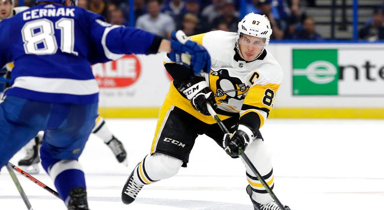 Pittsburgh Penguins center Sidney Crosby (87) moves the puck toward Tampa Bay Lightning defenseman Erik Cernak (81) during the first period of an NHL hockey game Wednesday, Oct. 23, 2019, in Tampa, Fla.