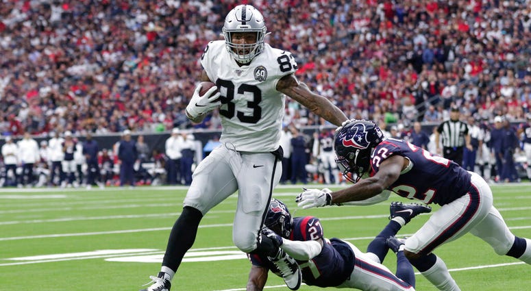 Oakland Raiders tight end Darren Waller (83) scores a touchdown past Houston Texans cornerback Gareon Conley (22) after a catch during the first half of an NFL football game Sunday, Oct. 27, 2019, in Houston. ap do not use
