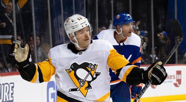 Pittsburgh Penguins right wing Bryan Rust celebrates after scoring a goal against the New York Islanders during the third period of an NHL hockey game, Thursday, Nov. 7, 2019, in New York. The Penguins won 4-3. Pittsburgh Penguins right wing Bryan Rust celebrates after scoring a goal against the New York Islanders during the third period of an NHL hockey game, Thursday, Nov. 7, 2019, in New York. The Penguins won 4-3.