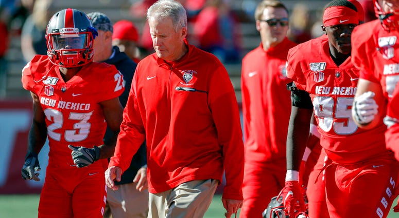 In this Saturday, Oct. 26, 2019, file photo, New Mexico coach Bob Davie leads his team from the field at halftime of an NCAA college football game against Hawaii in Albuquerque, N.M. AP DO NOT USE