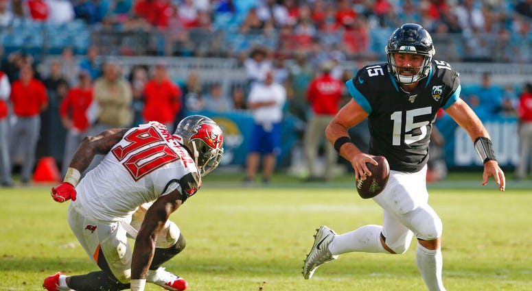 Jacksonville Jaguars quarterback Gardner Minshew (15) scrambles away from Tampa Bay Buccaneers linebacker Jason Pierre-Paul (90) during the second half of an NFL football game, Sunday Dec. 1, 2019, in Jacksonville, Fla. Jacksonville Jaguars quarterback Gardner Minshew (15) scrambles away from Tampa Bay Buccaneers linebacker Jason Pierre-Paul (90) during the second half of an NFL football game, Sunday Dec. 1, 2019, in Jacksonville, Fla.
