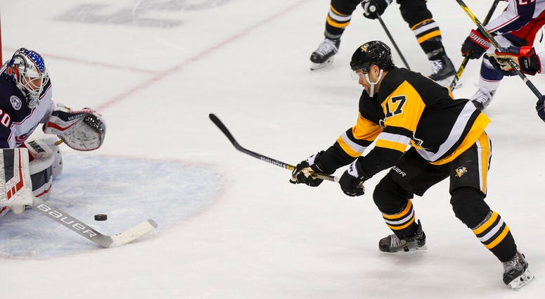 Pittsburgh Penguins' Bryan Rust (17) shoots and scores the game winning goal on Columbus Blue Jackets goaltender Joonas Korpisalo, left, during the overtime period of an NHL hockey game, Thursday, Dec. 12, 2019, in Pittsburgh. Pittsburgh Penguins won 1-0. Pittsburgh Penguins' Bryan Rust (17) shoots and scores the game winning goal on Columbus Blue Jackets goaltender Joonas Korpisalo, left, during the overtime period of an NHL hockey game, Thursday, Dec. 12, 2019, in Pittsburgh. Pittsburgh Penguins won 1-0.