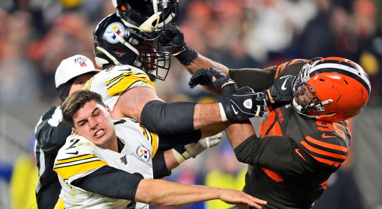 Cleveland Browns defensive end Myles Garrett hits Pittsburgh Steelers quarterback Mason Rudolph (2) with a helmet during the second half of an NFL football game, Nov. 14, 2019, in Cleveland. Cleveland Browns defensive end Myles Garrett hits Pittsburgh Steelers quarterback Mason Rudolph (2) with a helmet during the second half of an NFL football game, Nov. 14, 2019, in Cleveland.