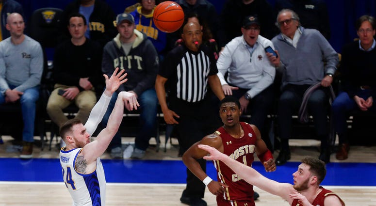 Pittsburgh's Ryan Murphy (24) hits a shot to put Pitt ahead to stay over Boston College's Nik Popovic with under five seconds left in the second half of an NCAA college basketball game, Wednesday, Jan. 22, 2020, in Pittsburgh. Pittsburgh won 74-72.