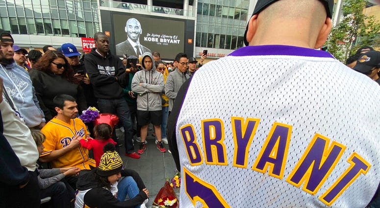 Fans mourn the loss of Kobe Bryant with makeshift memorials in front of La Live across from Staples Center, home of the Los Angeles Lakers in Los Angeles on Sunday, Jan, 26, 2020. Bryant, the 18-time NBA All-Star who won five championships and became one